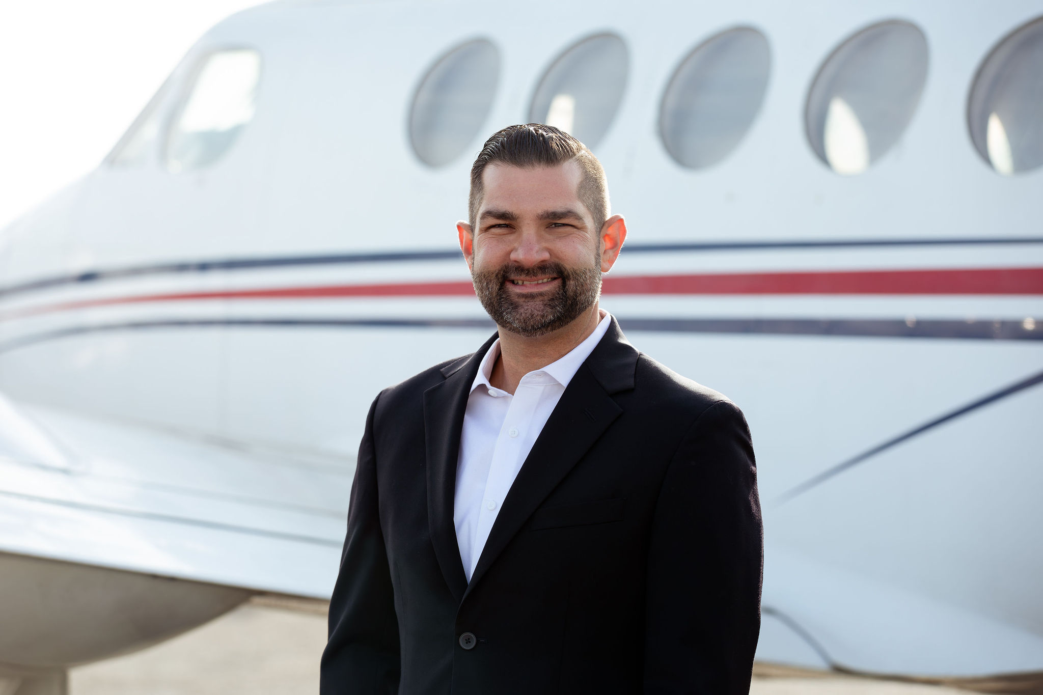 Brandon Martini standing in front of an aircraft