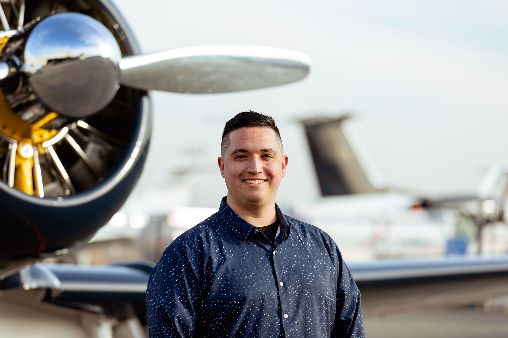 Carson Vasquez standing in front of an aircraft